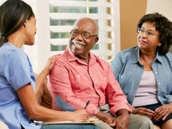 older man being assisted by a health professional
