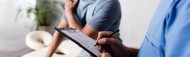 Health care provider holding a clipboard with a patient