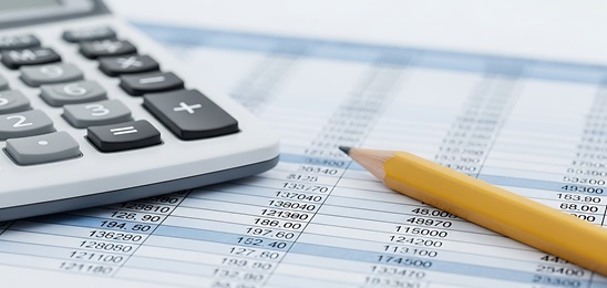Spreadsheet with a calculator and pencil