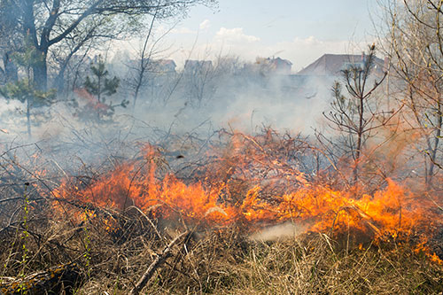 Large wildfire burning close to a home