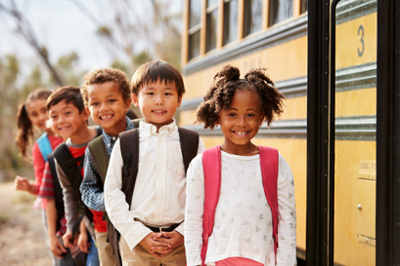 Kids boarding a yellow school bus