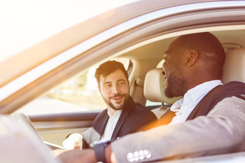 two people drive in a car