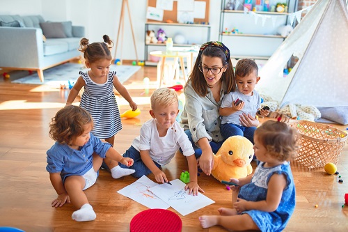 Child care worker seated on the floor