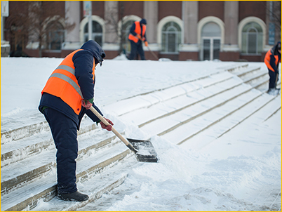 Workers shoveling snow.