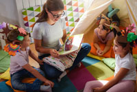 Woman packing folded clothes into box.