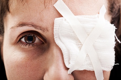 Woman with a bandage over her eye