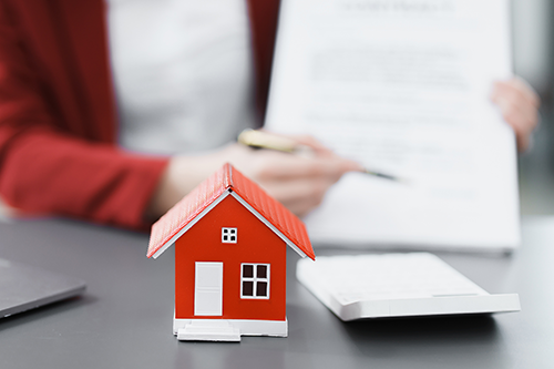 Toy red house on desk