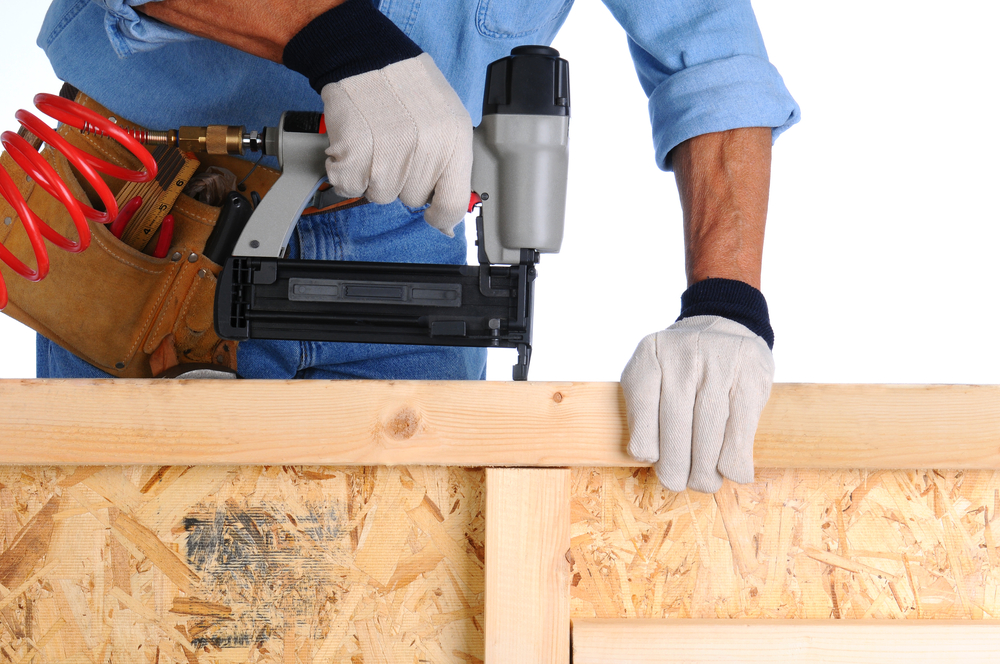 Worker using a nail gun