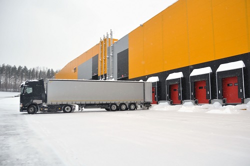 Winterize warehouse docks - truck backed up to a loading dock in snow