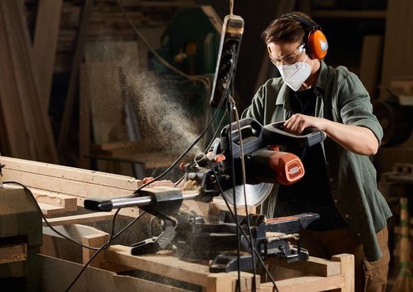 Woodworker using PPE